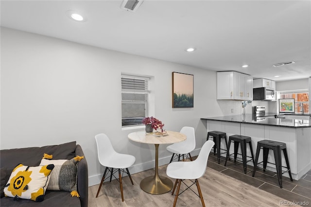 3443 Lawrence St, Denver, CO 80205 - dining area with light wood-style flooring and recessed lighting