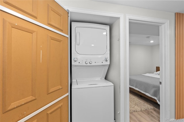 3443 Lawrence St, Denver, CO 80205 - laundry room with stacked washing machine and dryer and light wood-type flooring