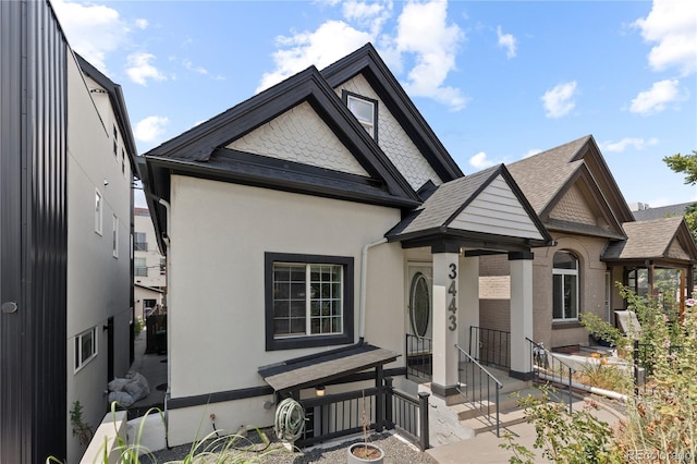 3443 Lawrence St, Denver, CO 80205 - view of front of home featuring stucco siding and a shingled roof
