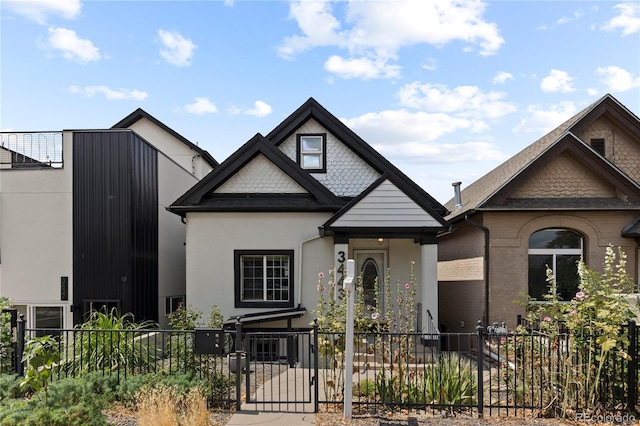 3443 Lawrence St, Denver, CO 80205 - view of front of home with a fenced front yard, a gate, and stucco siding