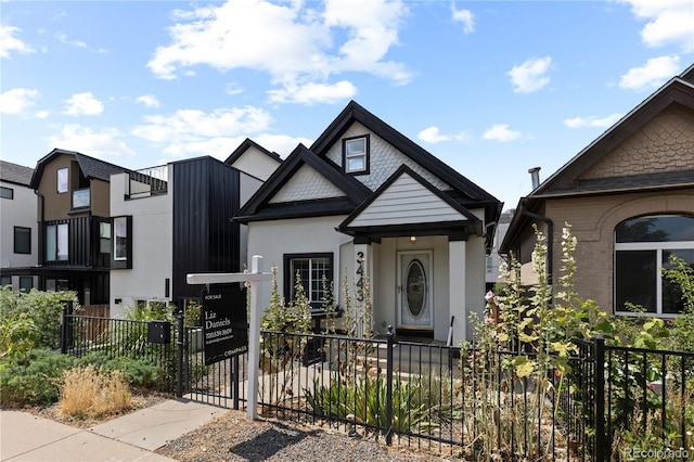 3443 Lawrence St, Denver, CO 80205 - view of front facade featuring a fenced front yard, stucco siding, and a gate