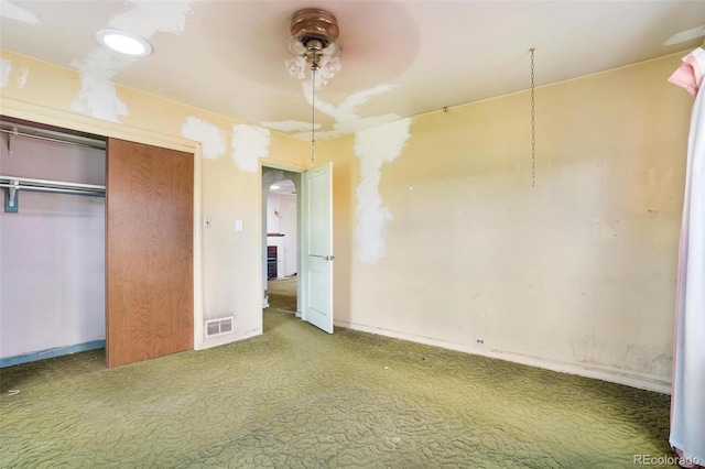 unfurnished bedroom featuring ceiling fan, carpet, baseboards, visible vents, and a closet