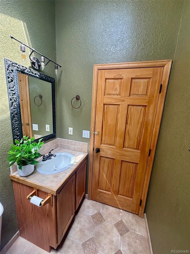 33508 Persistence Ave, Pine, CO 80470 - bathroom with vanity, a textured wall, and tile patterned floors