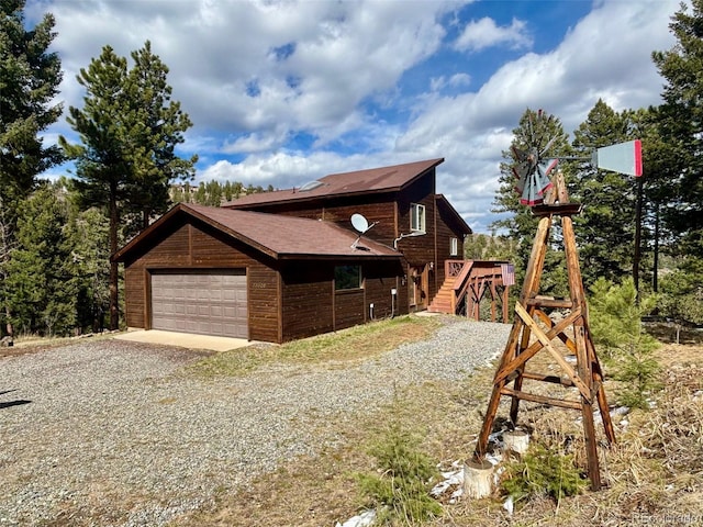 33508 Persistence Ave, Pine, CO 80470 - view of side of home with stairway and a shingled roof