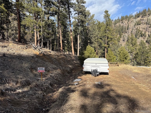 33508 Persistence Ave, Pine, CO 80470 - view of yard with a wooded view
