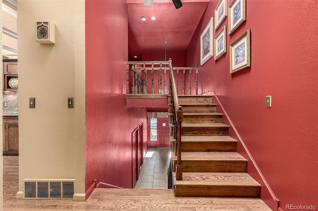 stairway with ceiling fan