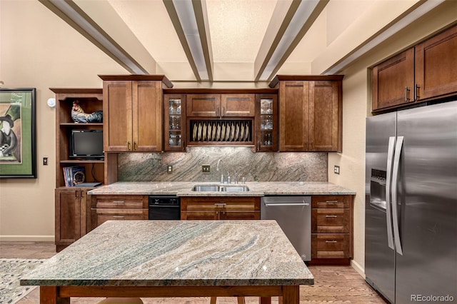 kitchen featuring sink, light hardwood / wood-style flooring, stainless steel appliances, light stone countertops, and decorative backsplash