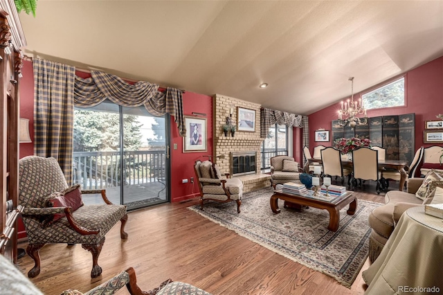 living room featuring an inviting chandelier, a fireplace, and plenty of natural light