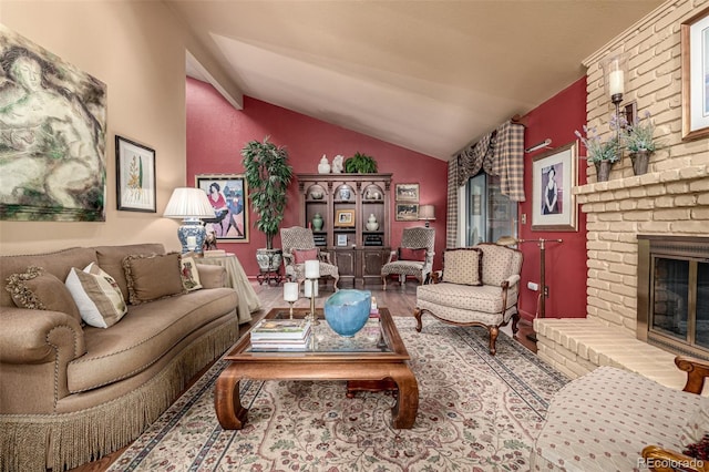 sitting room featuring a fireplace, hardwood / wood-style flooring, and vaulted ceiling