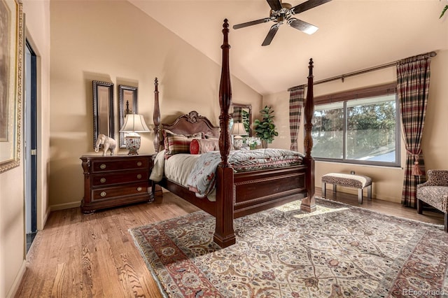 bedroom with vaulted ceiling, ceiling fan, and light wood-type flooring