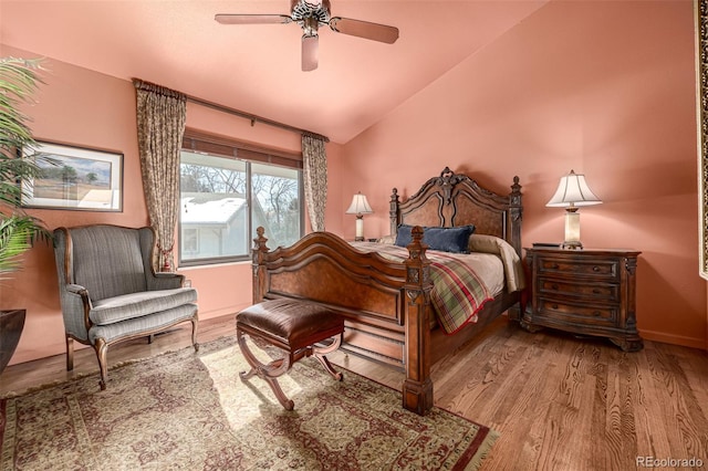 bedroom featuring ceiling fan, vaulted ceiling, and light hardwood / wood-style flooring