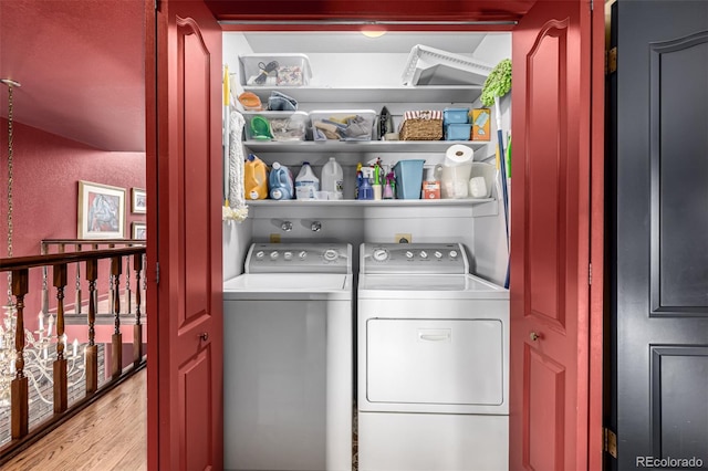 laundry room with washer and dryer and light wood-type flooring