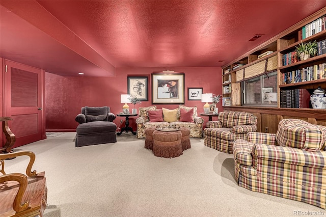 interior space featuring a textured ceiling and carpet flooring