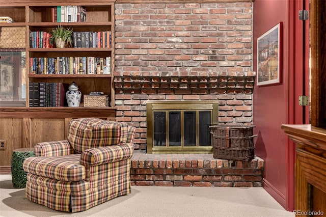 living room featuring a brick fireplace and carpet floors