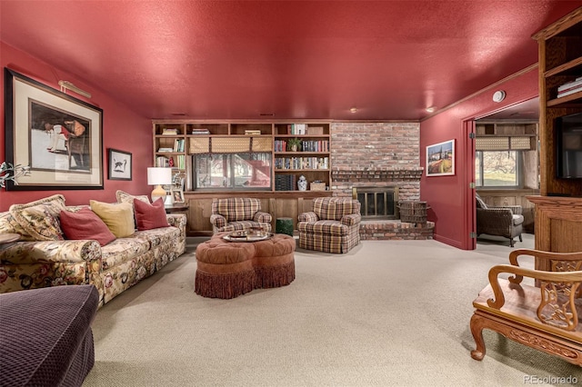 carpeted living room with a fireplace and a textured ceiling