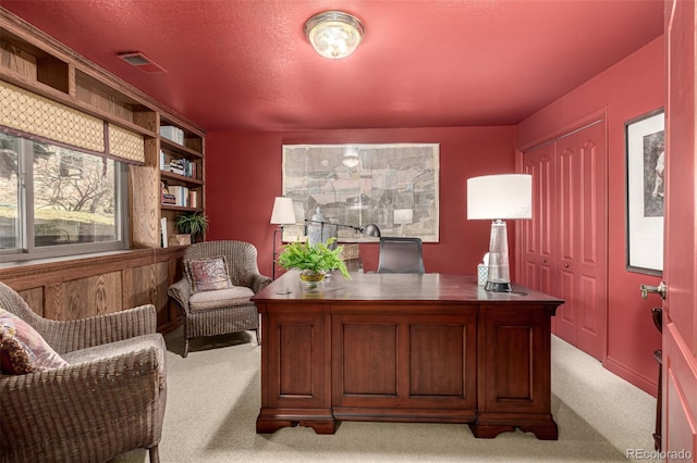 office with light carpet and a textured ceiling