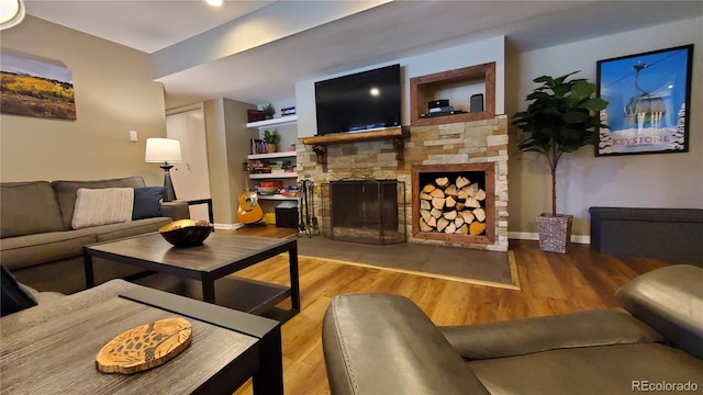 living room featuring a fireplace and wood-type flooring