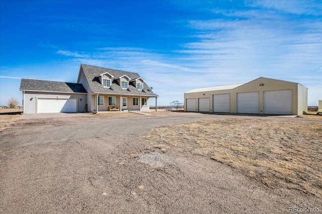 view of front of property with a garage and a shingled roof