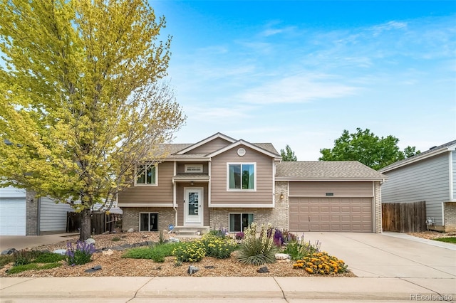 1482 S Pitkin Cir, Aurora, CO 80017 - bi-level home with brick siding, an attached garage, and concrete driveway