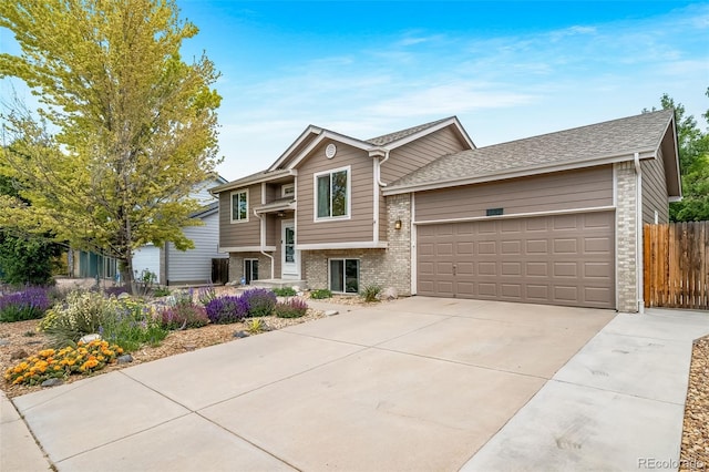 1482 S Pitkin Cir, Aurora, CO 80017 - view of front facade with an attached garage, brick siding, driveway, and a shingled roof