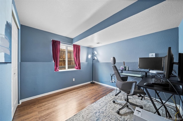1482 S Pitkin Cir, Aurora, CO 80017 - office space featuring wood finished floors, a textured wall, and a textured ceiling