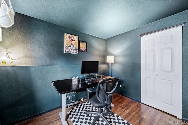 1482 S Pitkin Cir, Aurora, CO 80017 - office featuring dark wood finished floors, a textured wall, and a textured ceiling