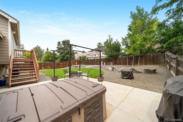 1482 S Pitkin Cir, Aurora, CO 80017 - fenced backyard featuring a hot tub, stairs, a patio, and grilling area