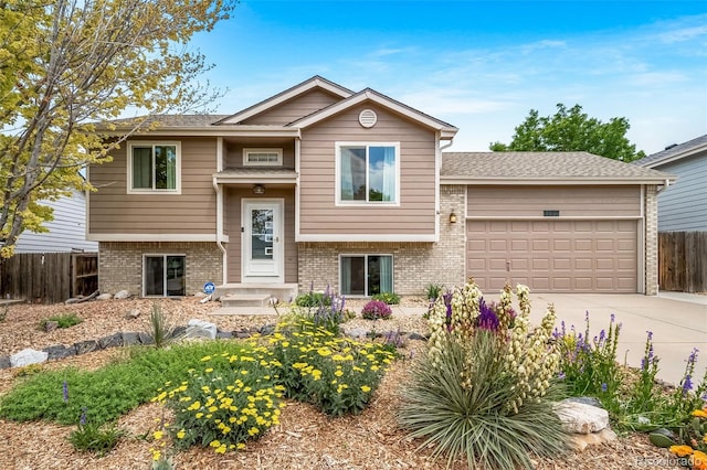 1482 S Pitkin Cir, Aurora, CO 80017 - raised ranch featuring brick siding, driveway, and an attached garage