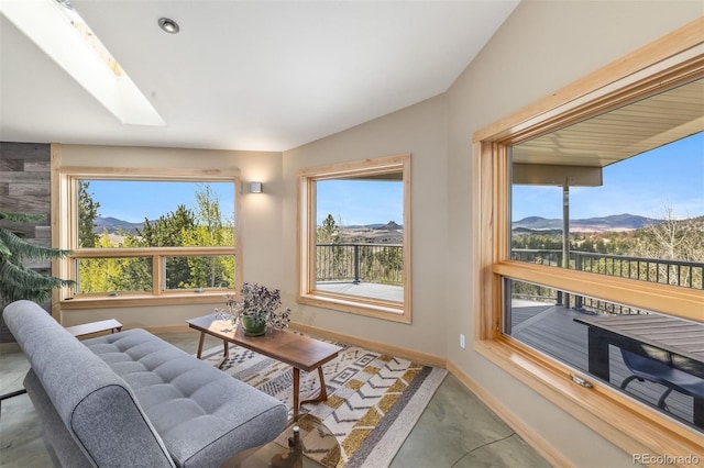 551 Spade Pl, Jefferson, CO 80456 - living area featuring a skylight, a mountain view, baseboards, concrete floors, and lofted ceiling