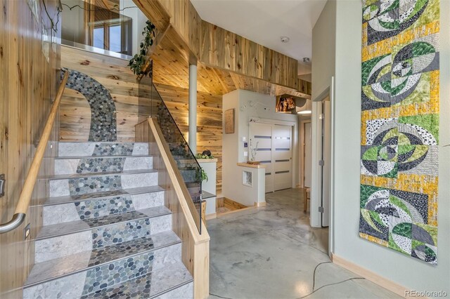 551 Spade Pl, Jefferson, CO 80456 - stairway featuring concrete flooring, wood walls, and baseboards