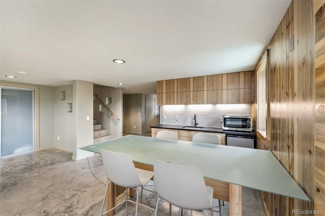 551 Spade Pl, Jefferson, CO 80456 - kitchen featuring stainless steel appliances, a sink, modern cabinets, tasteful backsplash, and dark countertops