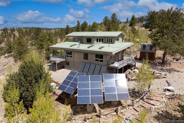551 Spade Pl, Jefferson, CO 80456 - rear view of house featuring ground mounted solar panels and metal roof