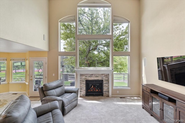 12671 Home Farm Ln, Westminster, CO 80234 - living room with a towering ceiling, a stone fireplace, carpet, and baseboards