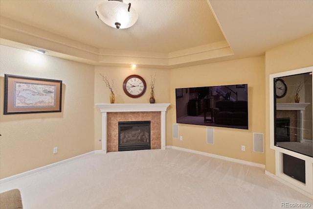 12671 Home Farm Ln, Westminster, CO 80234 - unfurnished living room featuring a fireplace, carpet flooring, a raised ceiling, and baseboards