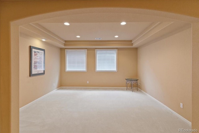 12671 Home Farm Ln, Westminster, CO 80234 - carpeted spare room featuring a tray ceiling, recessed lighting, baseboards, and arched walkways