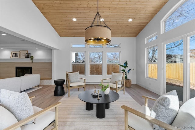 living room featuring wood ceiling, high vaulted ceiling, and light wood-type flooring