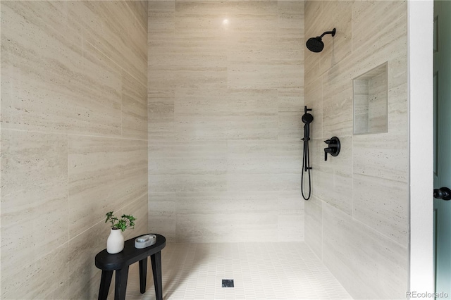 bathroom with a tile shower