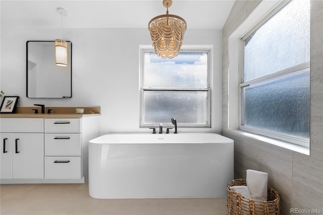 bathroom with vanity, a bath, and tile patterned flooring