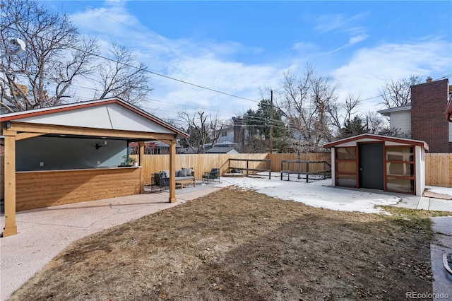 view of yard with a patio and a storage unit