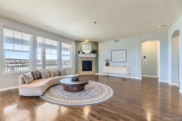 living room featuring a textured ceiling and dark hardwood / wood-style floors