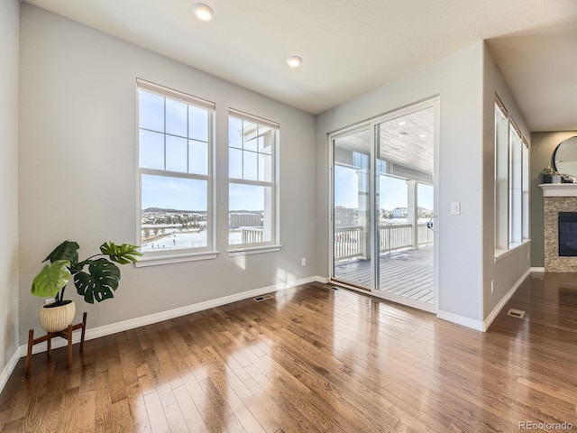 unfurnished room with a fireplace and hardwood / wood-style flooring