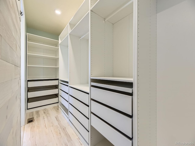 walk in closet featuring light hardwood / wood-style flooring