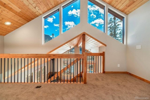 interior space with wood ceiling, high vaulted ceiling, and carpet floors