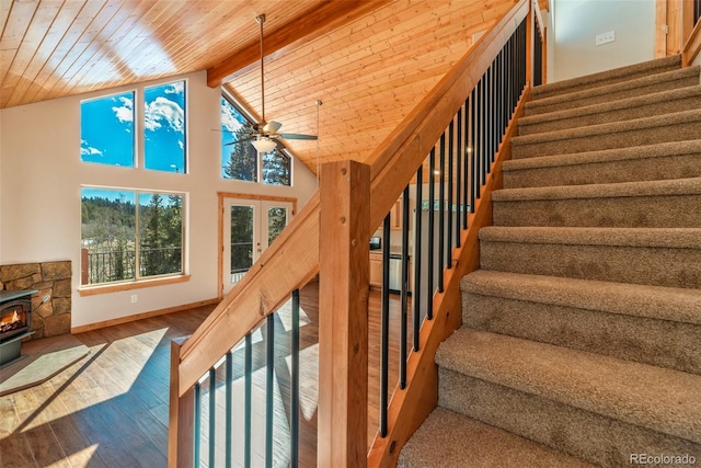 staircase with hardwood / wood-style flooring, ceiling fan, beam ceiling, high vaulted ceiling, and wooden ceiling