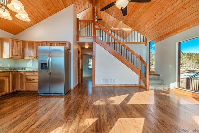 kitchen with wood ceiling, stainless steel fridge, ceiling fan, light stone countertops, and dark hardwood / wood-style flooring