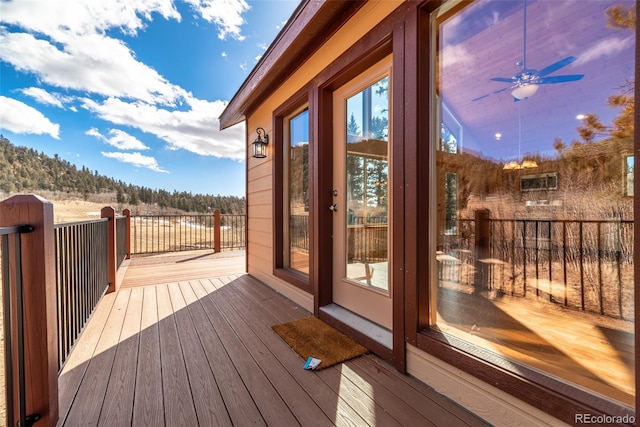 wooden terrace featuring ceiling fan