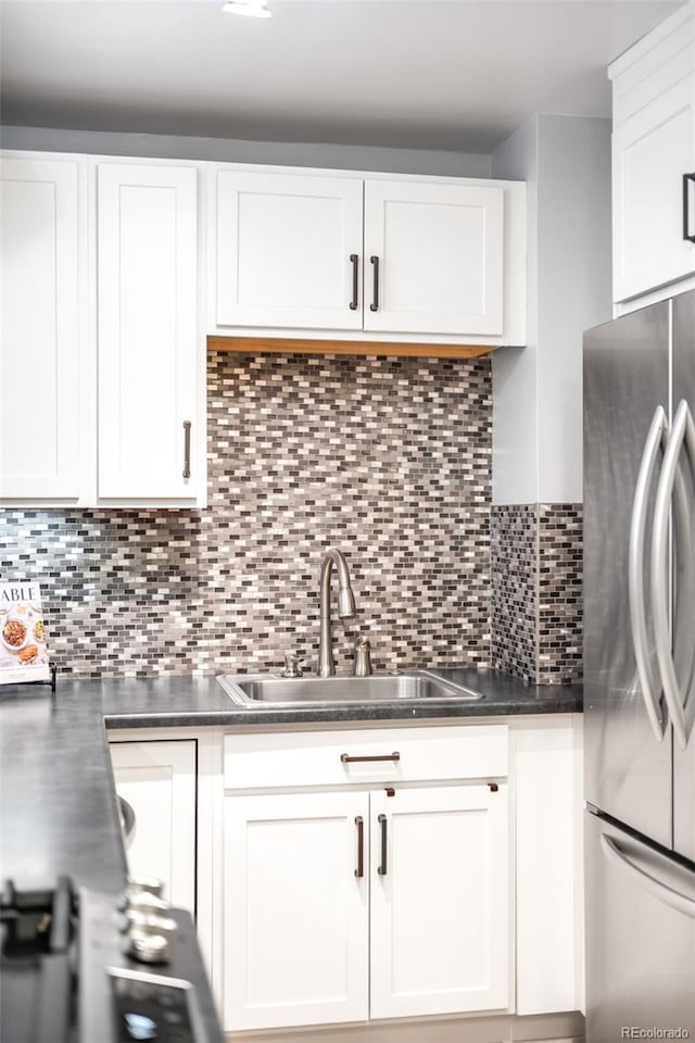 3425 W 34th Ave, Denver, CO 80211 - kitchen featuring freestanding refrigerator, a sink, white cabinetry, and dark countertops