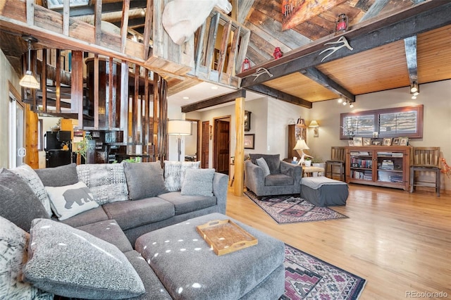 living room featuring wood finished floors, beam ceiling, and wood ceiling