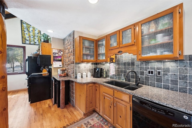 266 Lodgepole Dr, Evergreen, CO 80439 - kitchen featuring black dishwasher, glass insert cabinets, brown cabinets, light stone countertops, and a sink