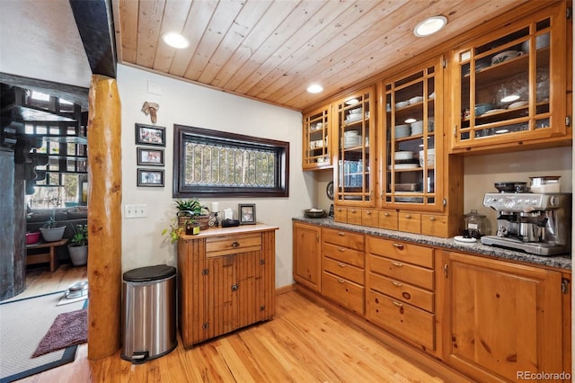 266 Lodgepole Dr, Evergreen, CO 80439 - kitchen featuring light wood finished floors, wood ceiling, glass insert cabinets, and brown cabinets